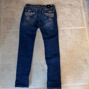 Miss Me low/mid-rise skinny jeans. Angel wing and cross pockets.